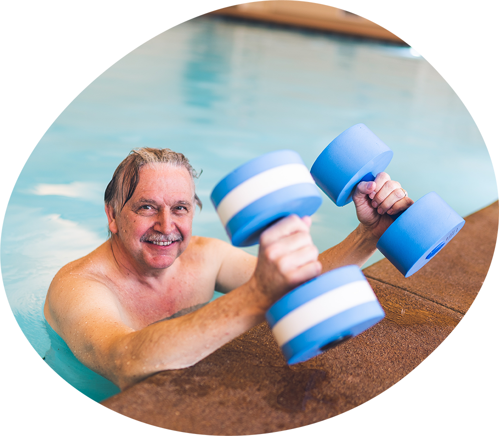 Man in the pool holding weights